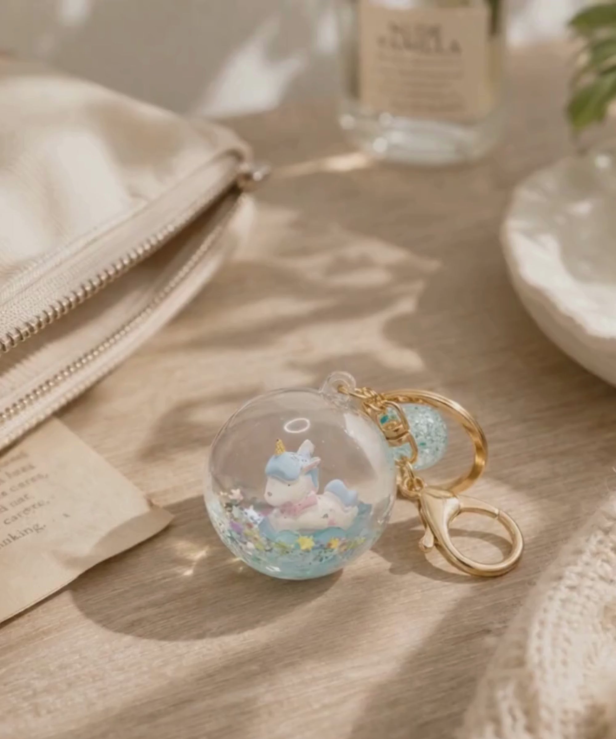 Unicorn liquid glitter keychain on table with soft lighting lifestyle scene