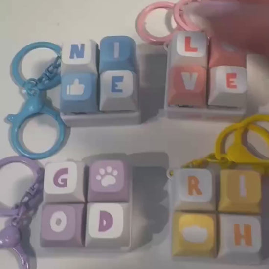 Mini keyboard fidget keychain video showing four designs and pressable keys