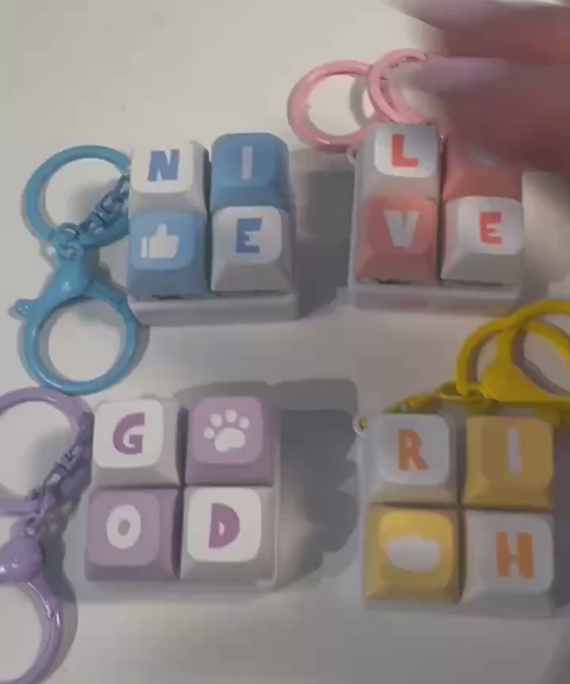 Mini keyboard fidget keychain video showing four designs and pressable keys