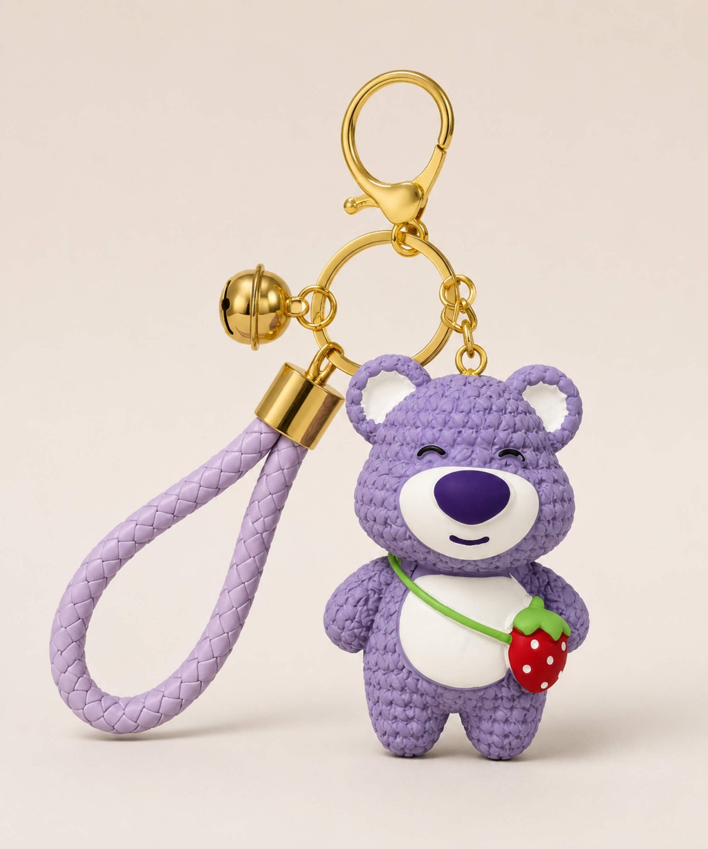 Purple strawberry bear resin keychain with braided wrist strap and gold keyring