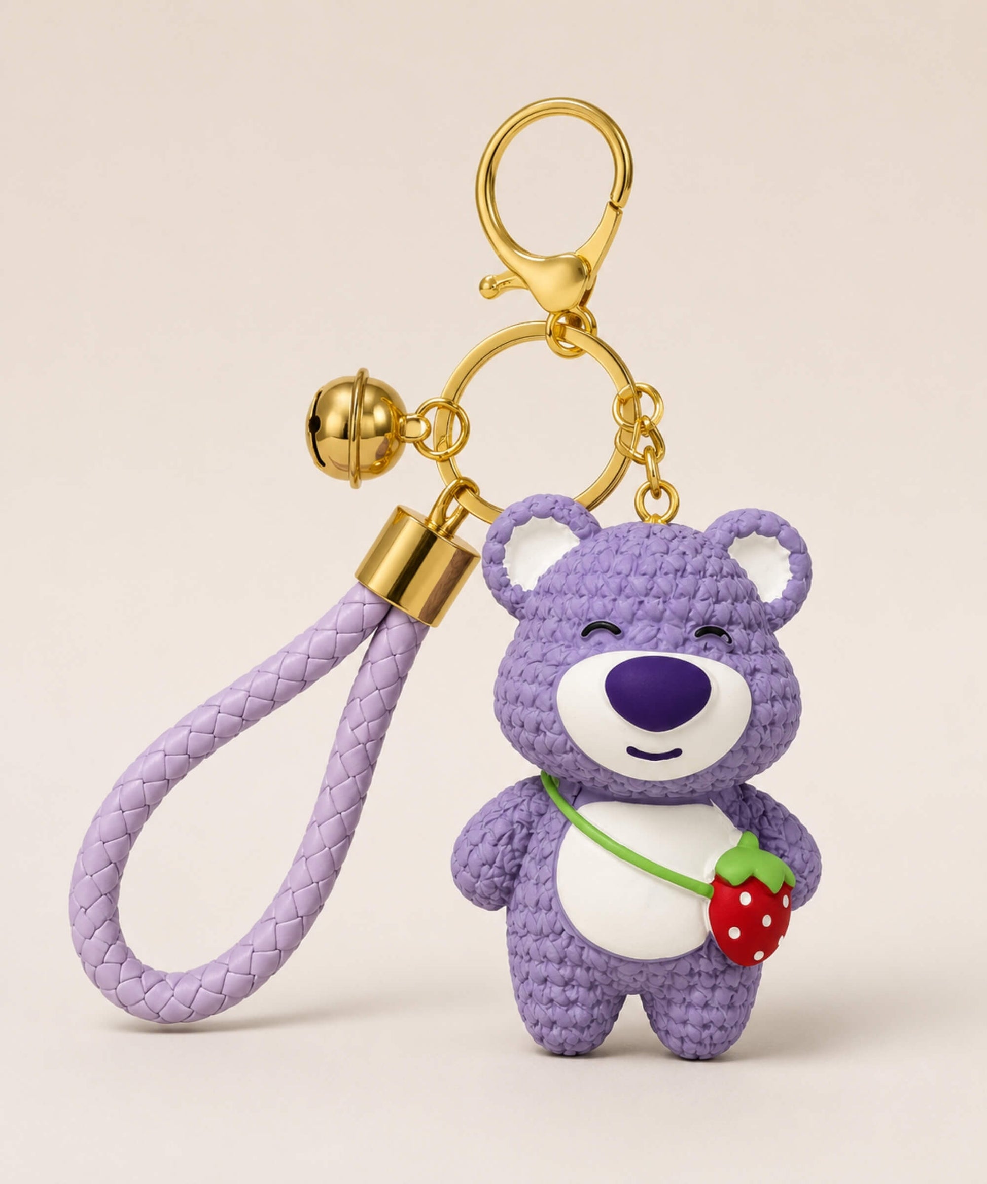 Purple strawberry bear resin keychain with braided wrist strap and gold keyring