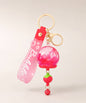 Red dried flower liquid quicksand keychain with apple charm and gold hardware