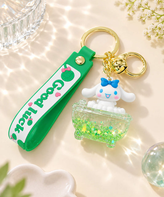 Cinnamoroll bathtub liquid keychain with green glitter bath charm, white character detail, green wrist strap and gold-tone hardware