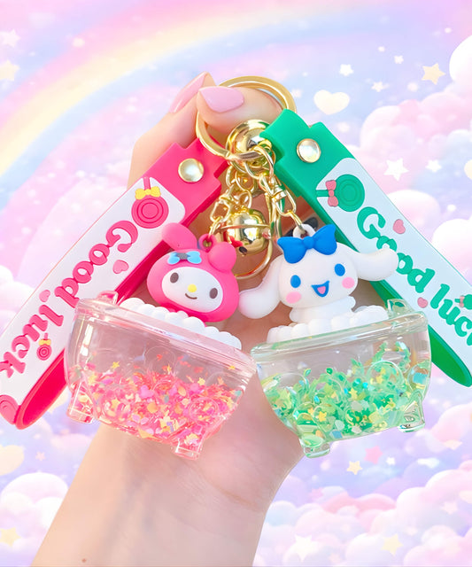 Sanrio bathtub liquid keychains with My Melody and Cinnamoroll designs held in hand, cute glitter bath shaker charms with pastel background