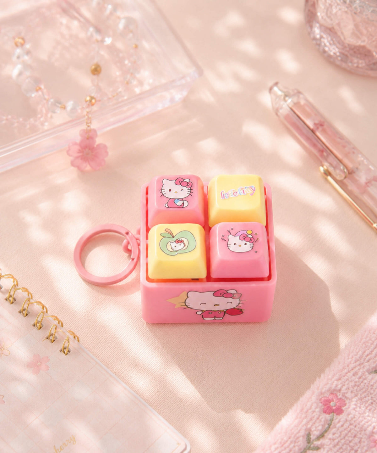 Pink Sanrio character light-up sound button keychain with four interactive buttons and keyring