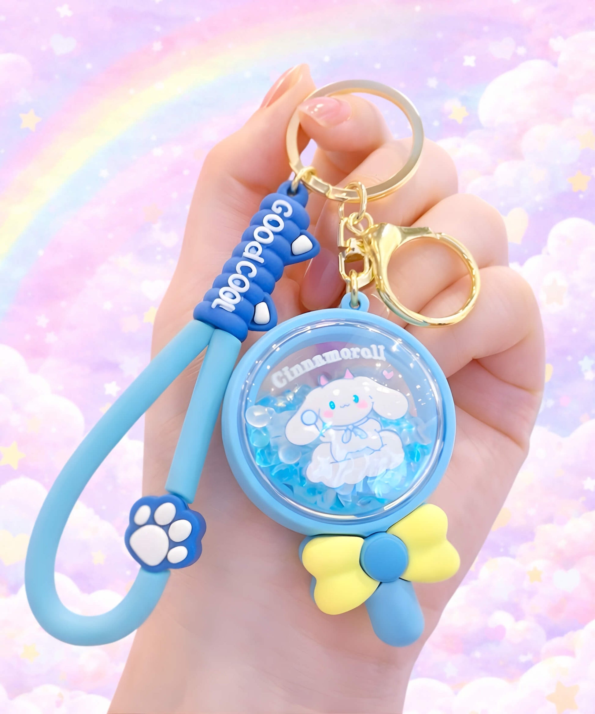 Sanrio Cinnamoroll bead shaker keychain lollipop design held in hand, scented floating bead charm with pastel rainbow background