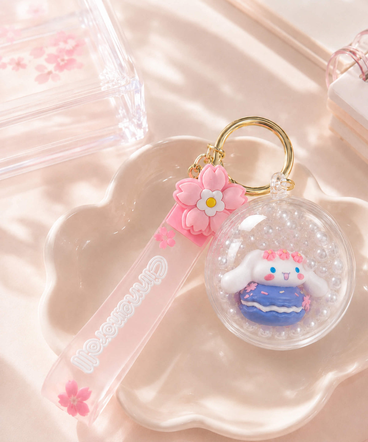 Sanrio Cinnamoroll shaker keychain with floating pearl beads, clear round charm and pink strap