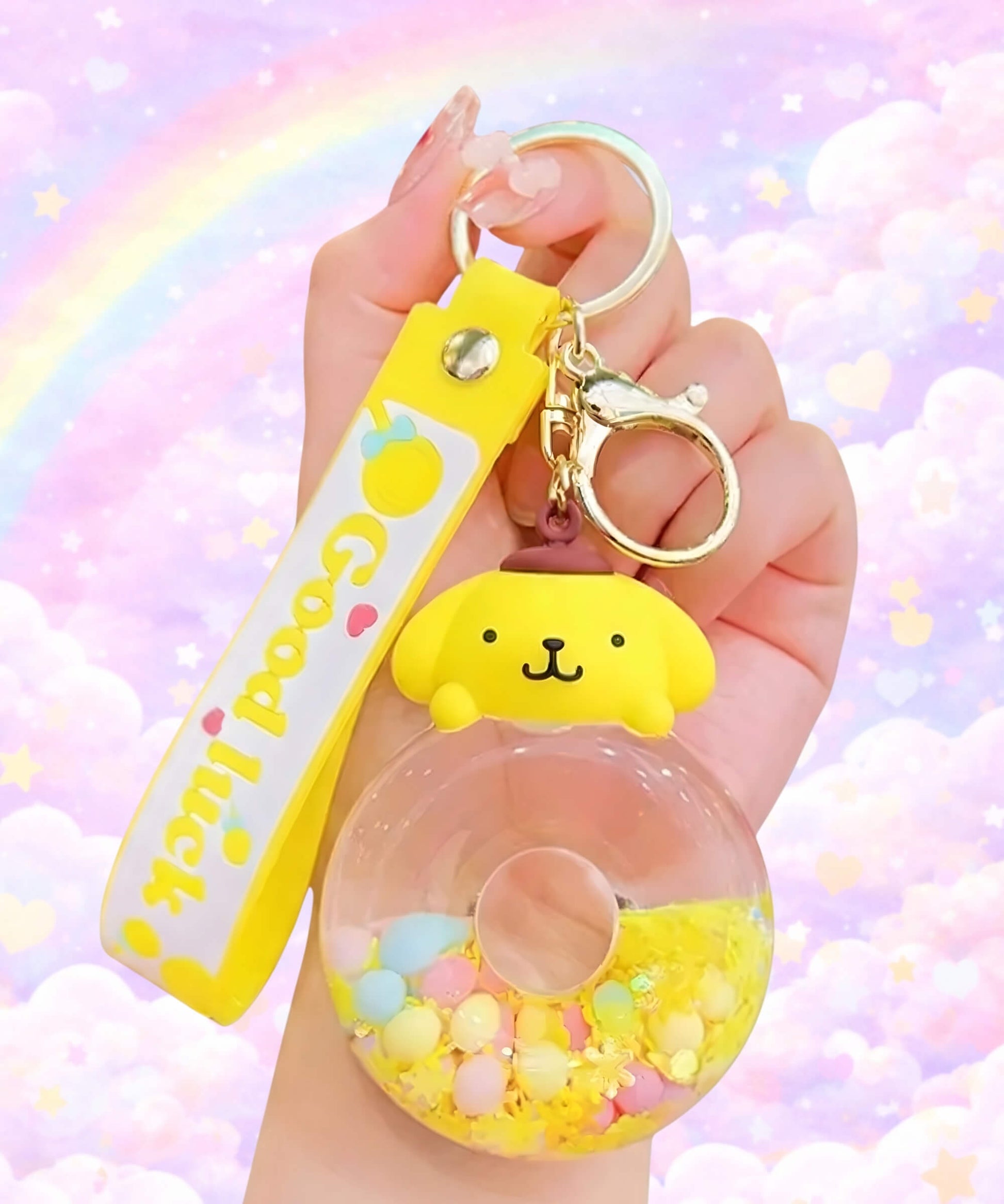Sanrio donut liquid keychain with Pompompurin design close up in hand, cute shaker charm with floating beads and pastel background