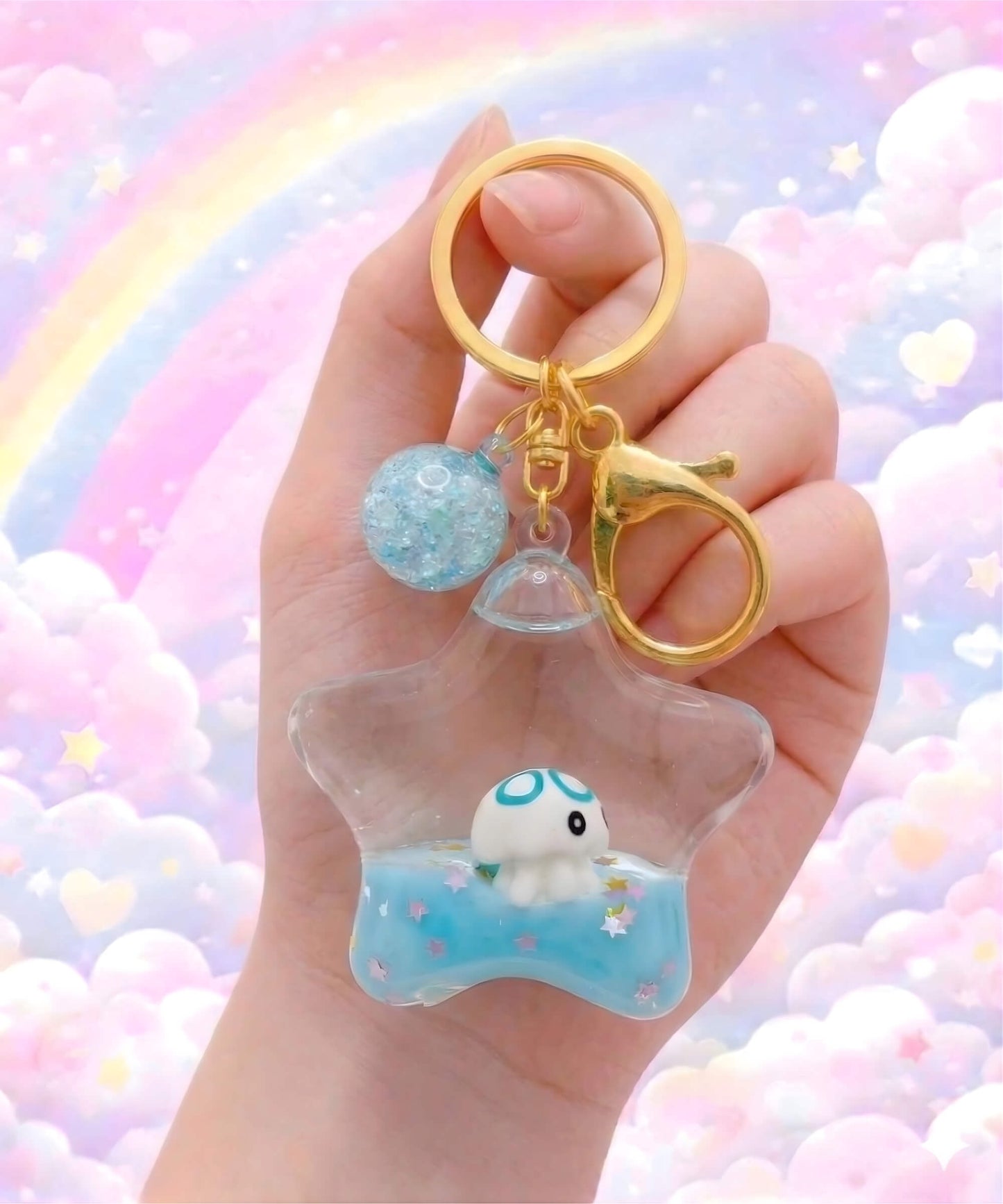 Star liquid glitter keychain with octopus design held in hand, cute floating ocean animal bag charm with pastel background