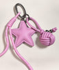 Pink star PU leather bag charm keychain with woven knot ball and metallic bead details