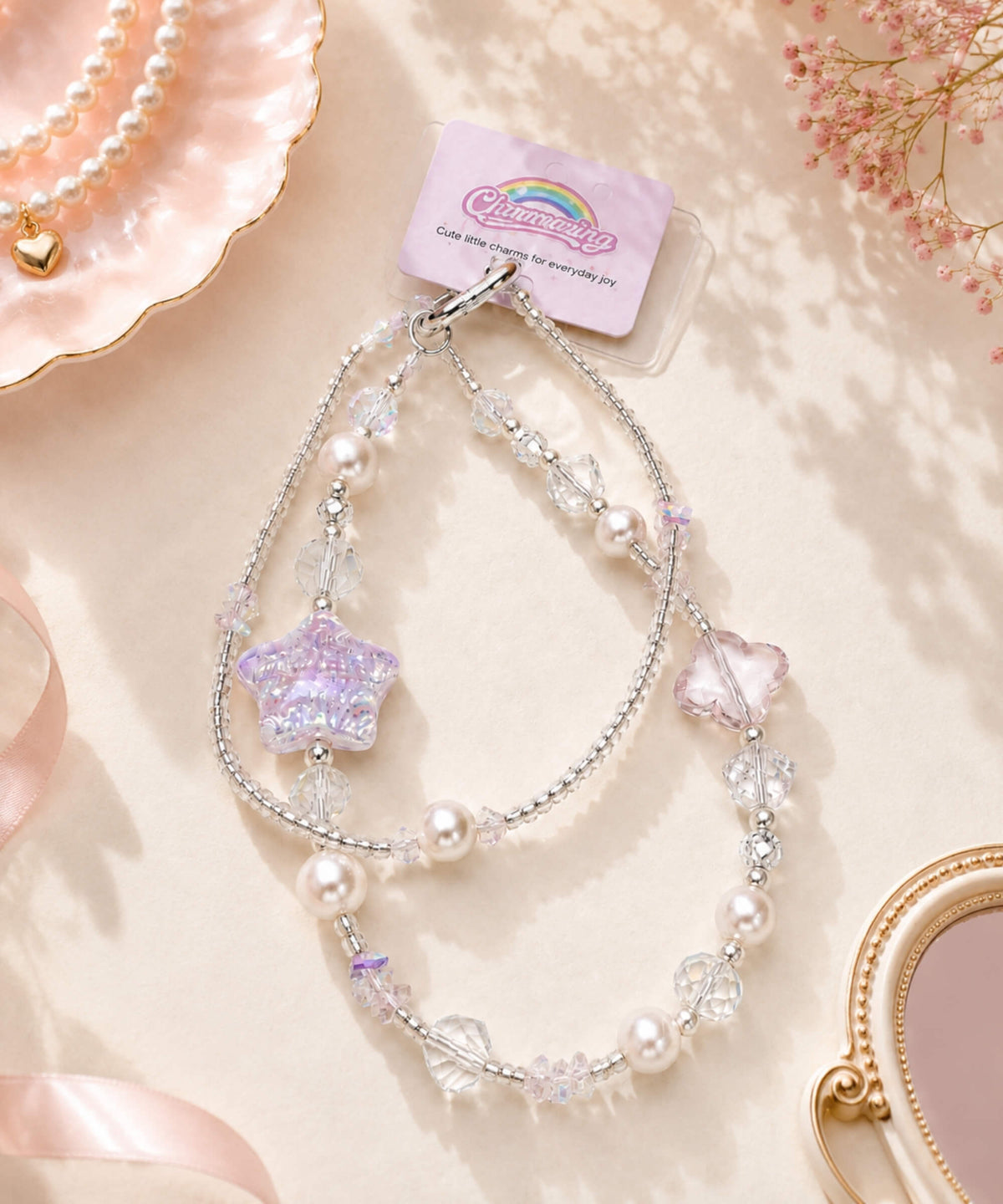 Purple Starry beaded phone charm with pearl-look and crystal-style beads in a soft pastel lifestyle setting