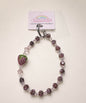 Dark purple strawberry beaded phone charm with mixed crystal-style beads and a sparkling strawberry charm