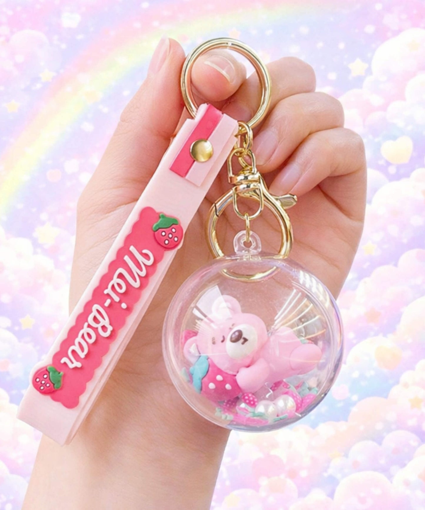 Strawberry bear shaker keychain with floating beads held in hand, cute kawaii bubble charm with pastel aesthetic