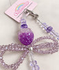 Close-up detail of the purple strawberry bow beaded phone charm with glossy strawberry bead and sparkly bow design