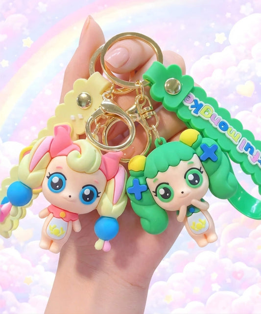 Teenieping style fairy character keychains held in hand, cute pastel girl bag charms with rainbow cloud background