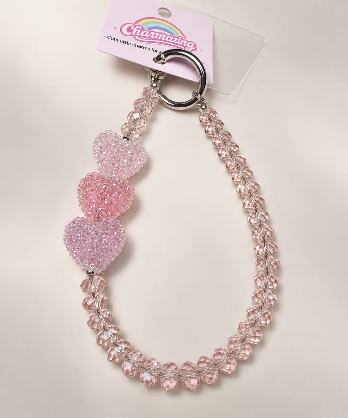 Close-up of pink crystal-style bead details on Triple Heart beaded phone charm