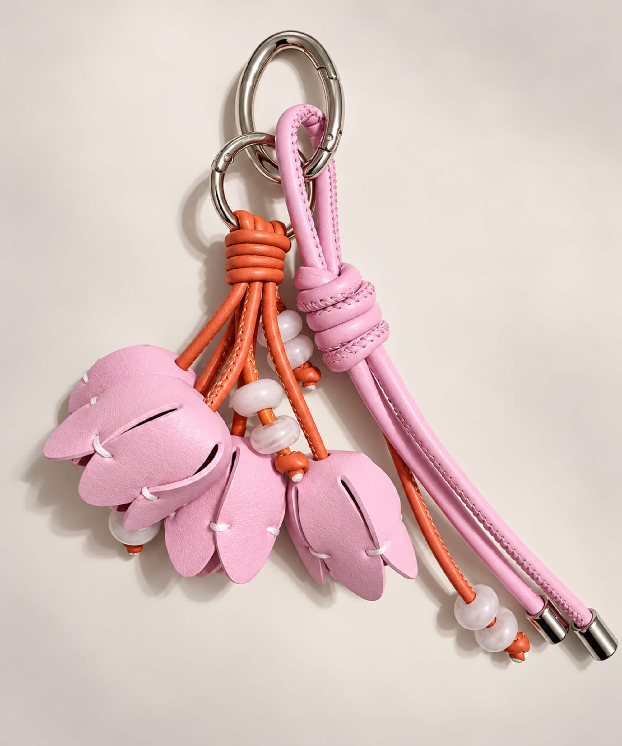 Pink tulip PU leather bag charm keychain with layered flower buds and orange cord details