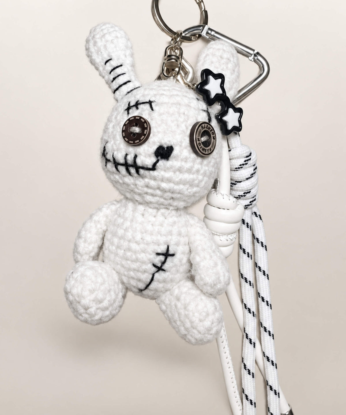 White voodoo bunny crochet keychain with button eyes and hanging cords