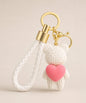 White knitted-look heart bear resin keychain with pink heart detail and white braided wrist strap