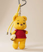 Winnie the Pooh style yellow crochet keychain with red top and hanging strap