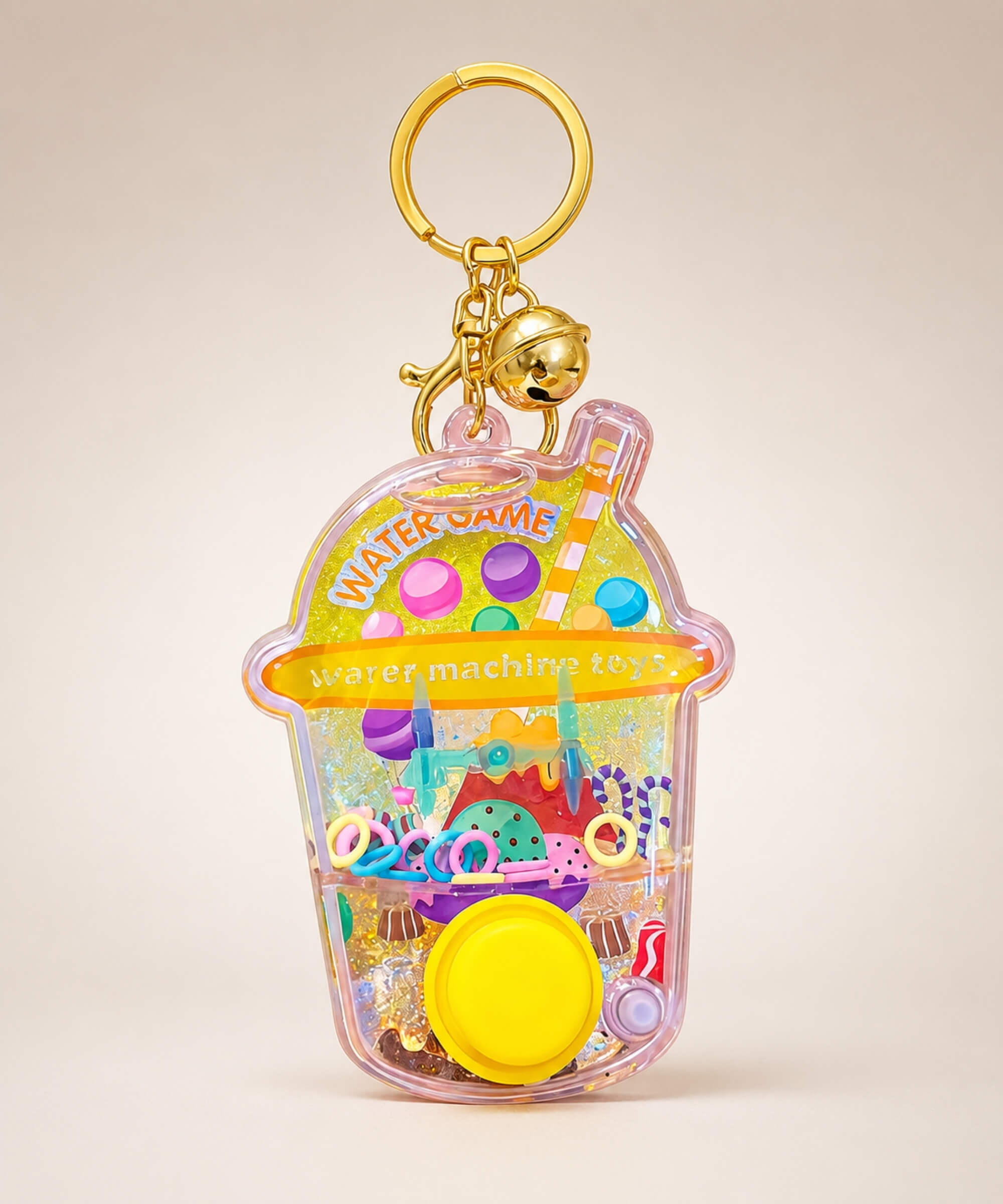 Yellow dessert water ring game keychain with button and gold bell